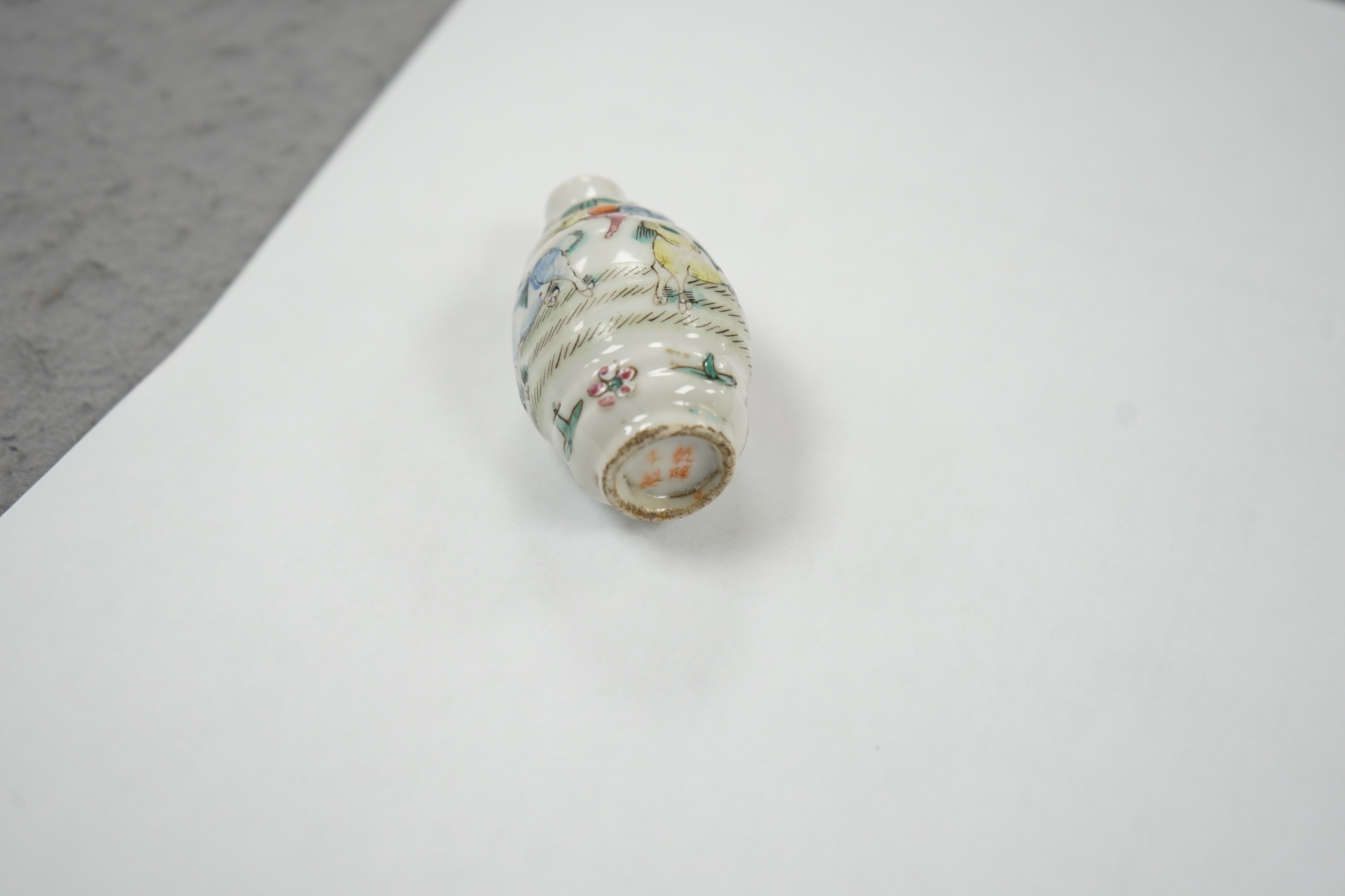 A Chinese famille rose snuff bottle, decorated with rams, Qianlong mark, 1850-1900, 6.7 cm high